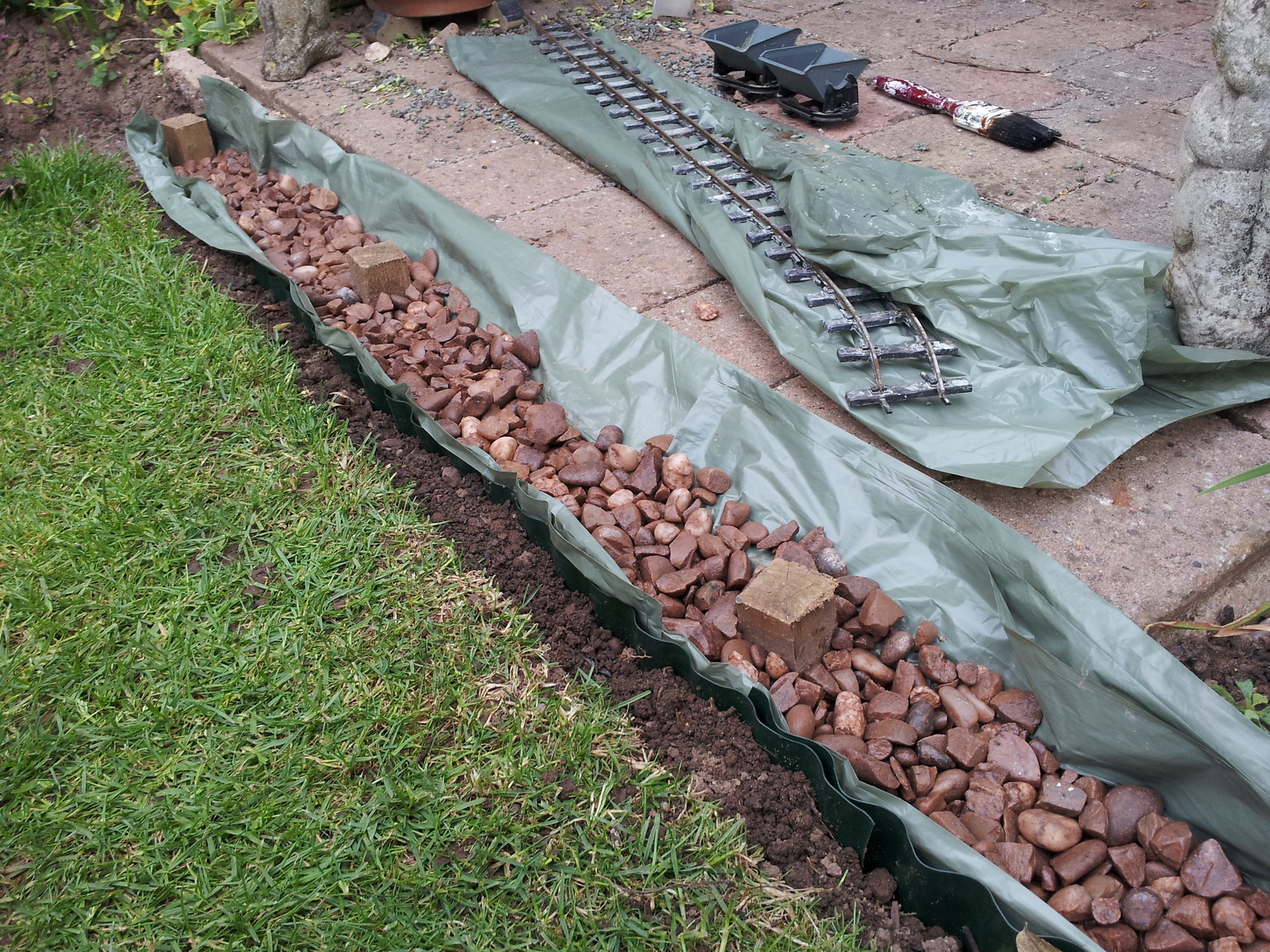 4 years ago - Soil liner, stones and stakes awaiting sand and tamping.
