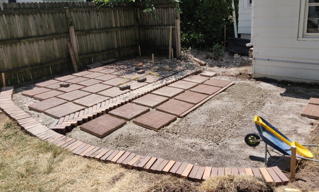 Paver patio in painfully protracted progress. The NVT will primarily occupy the space between the fence and the house.