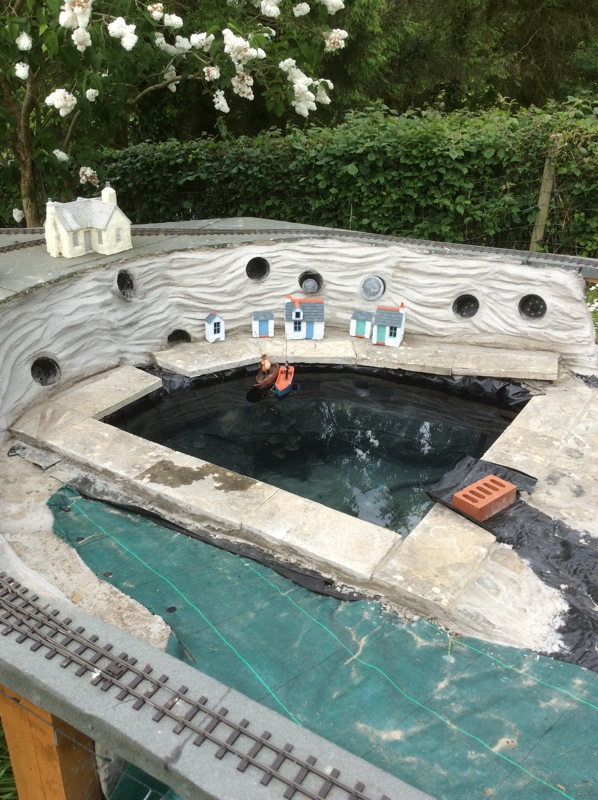 Some slabs laid around the edge of pond