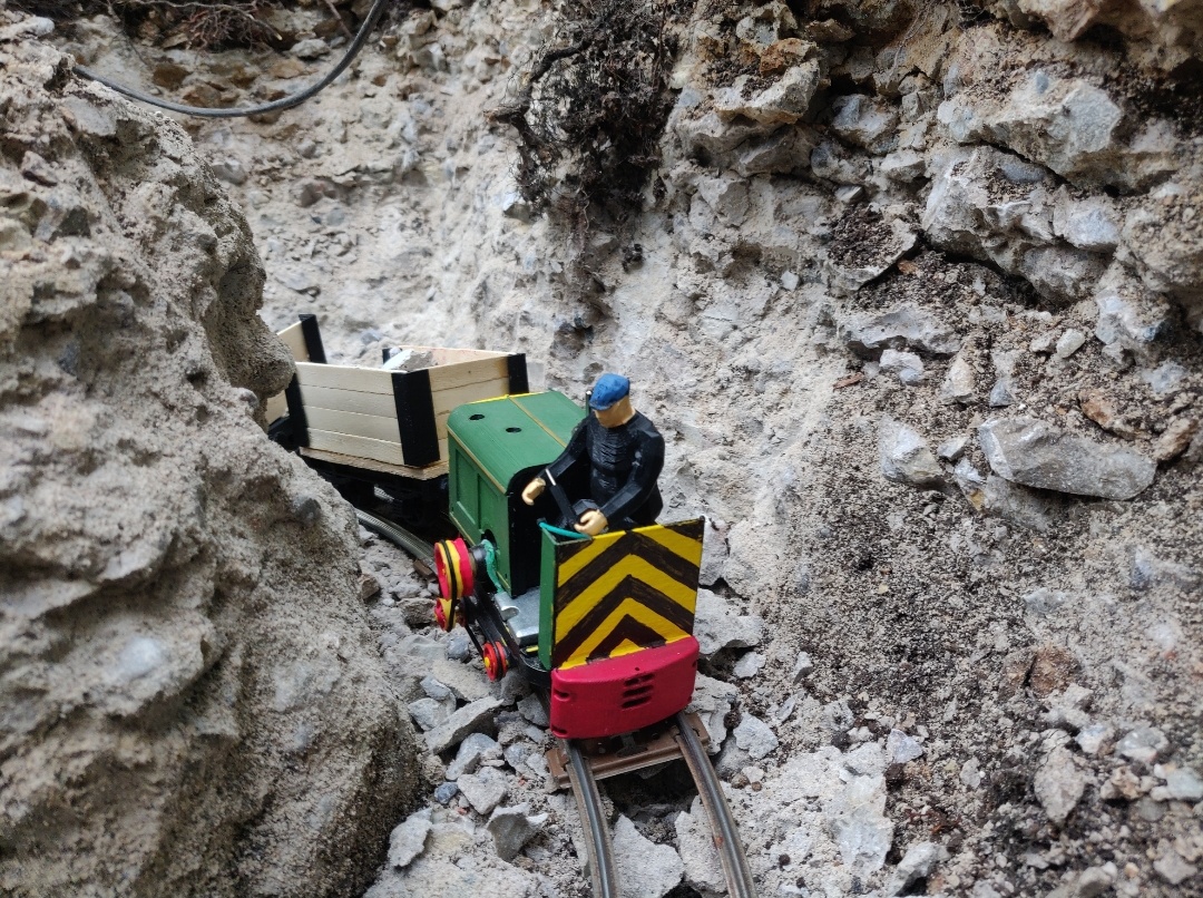 Industrial diesel 'Moke' pulls a stone train through a cutting in the quarry prior to its closure.