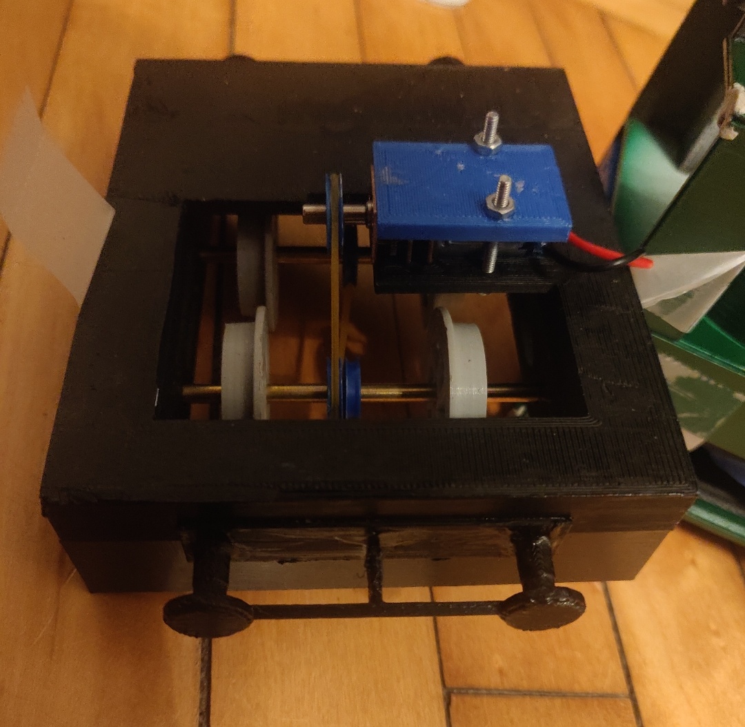 The running gear with tiny motor, and rubber bands standing in for belts-- one has already snapped, and they are not easy to replace on this design.